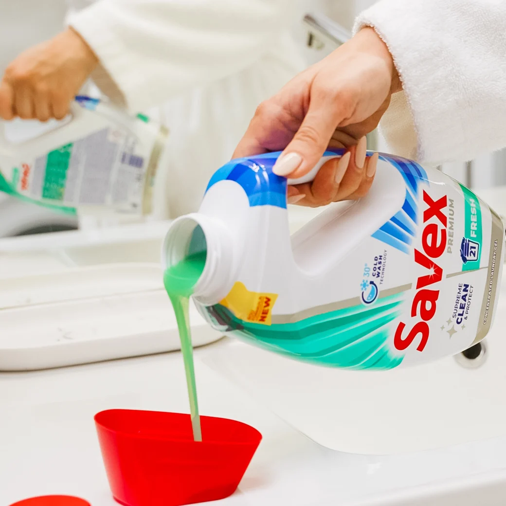 Pouring Savex Premium gel into the red measuring cap