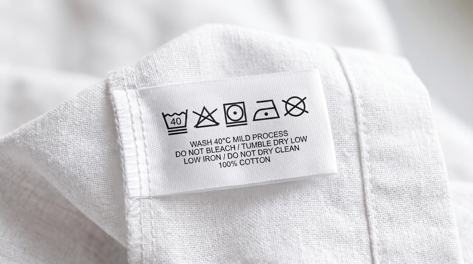 A garment care label with washing symbols